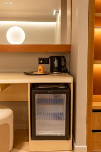 a small oven in a kitchen next to a table at Hotel Berfin in Vlorë