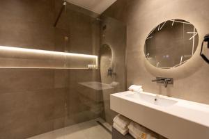 a bathroom with a sink and a shower with a mirror at Hotel Berfin in Vlorë +87 photos