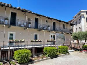 a building with flowerpots on the balconies of it at GIO' HOUSE in Fossano