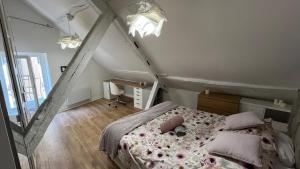 a bedroom with a bed with pink sheets and pillows at Lion Or - Downtown - Sens in Sens