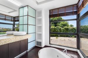 a bathroom with two sinks and a large window at Villa Panorama Kalathas - 4 Bedrooms Near beach in Chorafakia