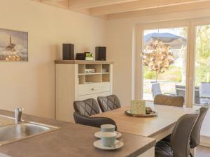 a kitchen and dining room with a table and a sink at Villa Milla - Nordhorn in Nordhorn