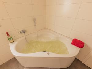 a bath tub filled with water in a bathroom at Villa Milla - Nordhorn in Nordhorn