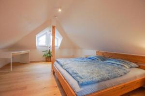 a bedroom with a wooden bed in a attic at Loft Heidelberg West in Heidelberg