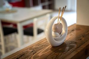 a white egg holder on a wooden table at Casa Gradita in Ponte Caffaro +21 photos