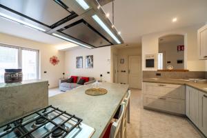 a kitchen and living room with a stove top oven at Casa Gradita in Ponte Caffaro