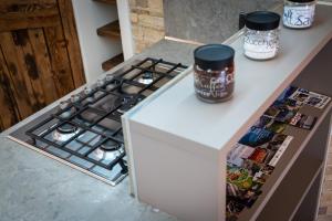 a white counter top with a stove in a kitchen at Casa Gradita in Ponte Caffaro