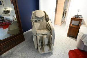 a chair sitting in a room next to a mirror at BluePrivateSpa in Latte