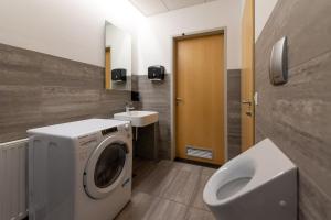 a bathroom with a washing machine and a sink at Old Town Guest Accommodation in Kranj