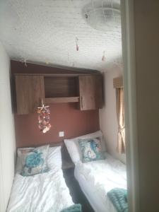 a small room with two beds in a room at Seaside Stay in Camber