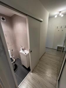 a small bathroom with a toilet and a door at Apartmán Košice Nad Jazerom in Košice +17 photos