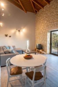 a living room with a table and chairs and a couch at Celeste Syvota in Syvota
