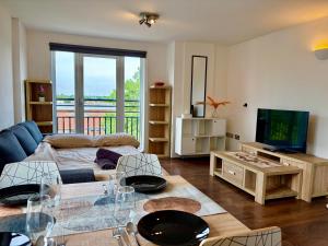 a living room with a couch and a tv at Stay in Stratford in London