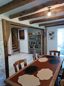 a dining room with a wooden table and chairs at Chez JF et ISA in Bussang