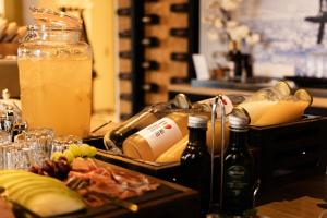 a table with some food and drinks and some bottles at Charley's Wellness Suite in Westkapelle