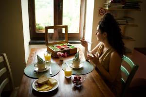 a young woman sitting at a table eating food at Agriturismo Giandriale in Tavarone