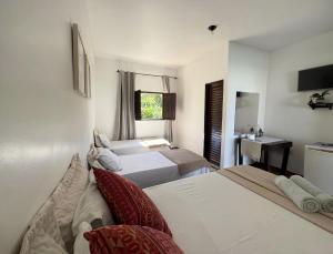 a hotel room with two beds and a sink at Pousada Sunflower in Pirenópolis +37 photos