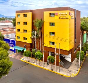 a yellow building with a hotel on top of it at Hotel & Villas Panamá in Mexico City