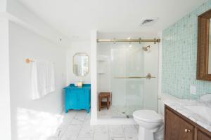 a bathroom with a toilet and a glass shower at The Parrish Grove Inn in Cocoa +58 photos