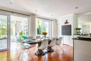 a kitchen and dining room with a table and chairs at Your homely experience in Paarl