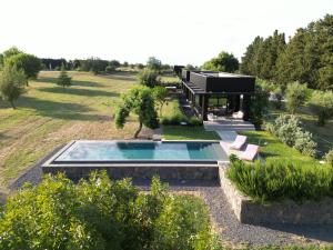 a house with a swimming pool in the middle of a yard at Scorzamara Country Lodges - Retreats with Private Pool or Jacuzzi in Carlentini +88 photos