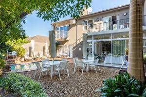 a house with a patio with a table and chairs at Your homely experience in Paarl