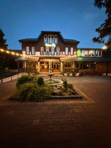 a large building with a fountain in front of it at Готель Пісня Гір in Ralevka +6 photos