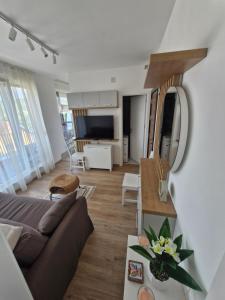 a living room with a couch and a table at Porodična oaza Vrnjačka Banja in Vrnjačka Banja