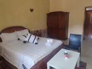 a small bedroom with a bed and a chair at Chambre d'hôte in Midelt