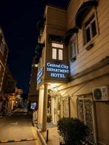a hotel sign on the side of a building at Central City Department Hotel in Baku