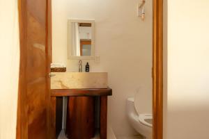 a bathroom with a sink and a toilet at DK Luxury Ocean Front Villa - Adults Only in Holbox Island +38 photos