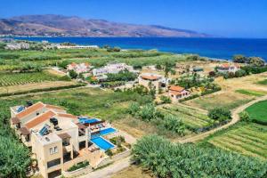 an aerial view of a villa with the ocean in the background at Corali Villas - Seaview, Private Pools, 450 to Beach in Kolymvari