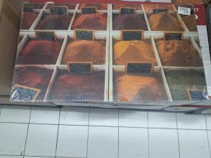 a display case filled with different types of spices at Appart Orangers in Les Orangers
