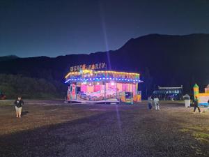 a merry go round is lit up at night at Appart Orangers in Les Orangers