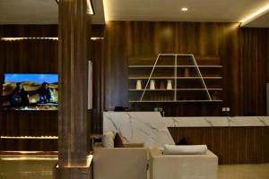 a living room with a couch and a tv at Sky view in Mahlal