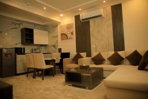 a living room with a couch and a table at Sky view in Mahlal