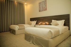 a hotel room with two beds and a couch at Sky view in Mahlal +81 photos