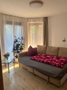 a large bed in a living room with a couch at Ferienwohnung Schwarzwald - Nähe der Schweiz in Hüfingen +25 photos