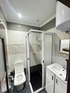 a bathroom with a shower and a toilet and a sink at JULYA appartement centre in Tangier