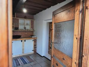 a kitchen with a wooden door in a room at Drevenica M&P 2 in Bešeňová +25 photos