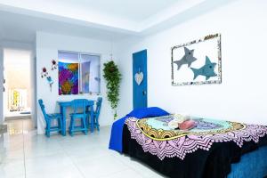 a bedroom with a bed and a table and chairs at Sunset View, Taganga in Taganga