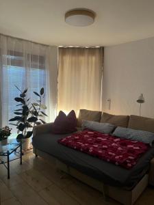 a living room with a couch with roses on it at Ferienwohnung Schwarzwald - Nähe der Schweiz in Hüfingen