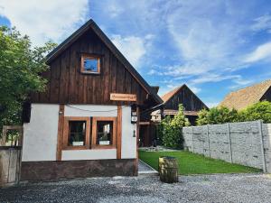 a wooden house with a window and a fence at Drevenica M&P 2 in Bešeňová