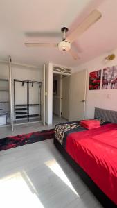 a bedroom with a red bed in a room at Rodadero Oasis in Santa Marta