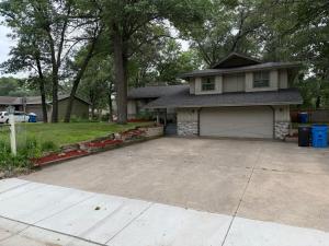 a house with a large driveway in front of it at Cedarwood Chateau in Cambridge