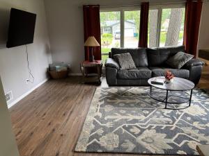 a living room with a couch and a table at Cedarwood Chateau in Cambridge