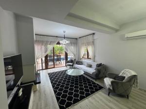 a living room with a couch and a table at Sadev Turizm Belek Family Villas in Belek +208 photos