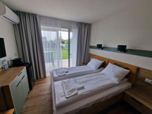 a bedroom with a bed and a large window at Willa Na Białej in Ziajki +44 photos