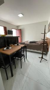a living room with a table and a bed at Flat em NATAL- RN in Natal +38 photos