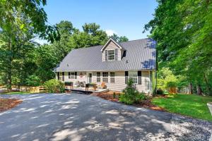 a white house with a driveway at Calm Water Cove in Nebo